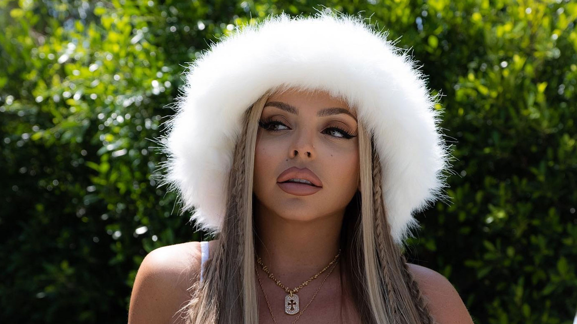 Jesy Nelson shows off her abs in a vest and huge fluffy hat after getting tattoo