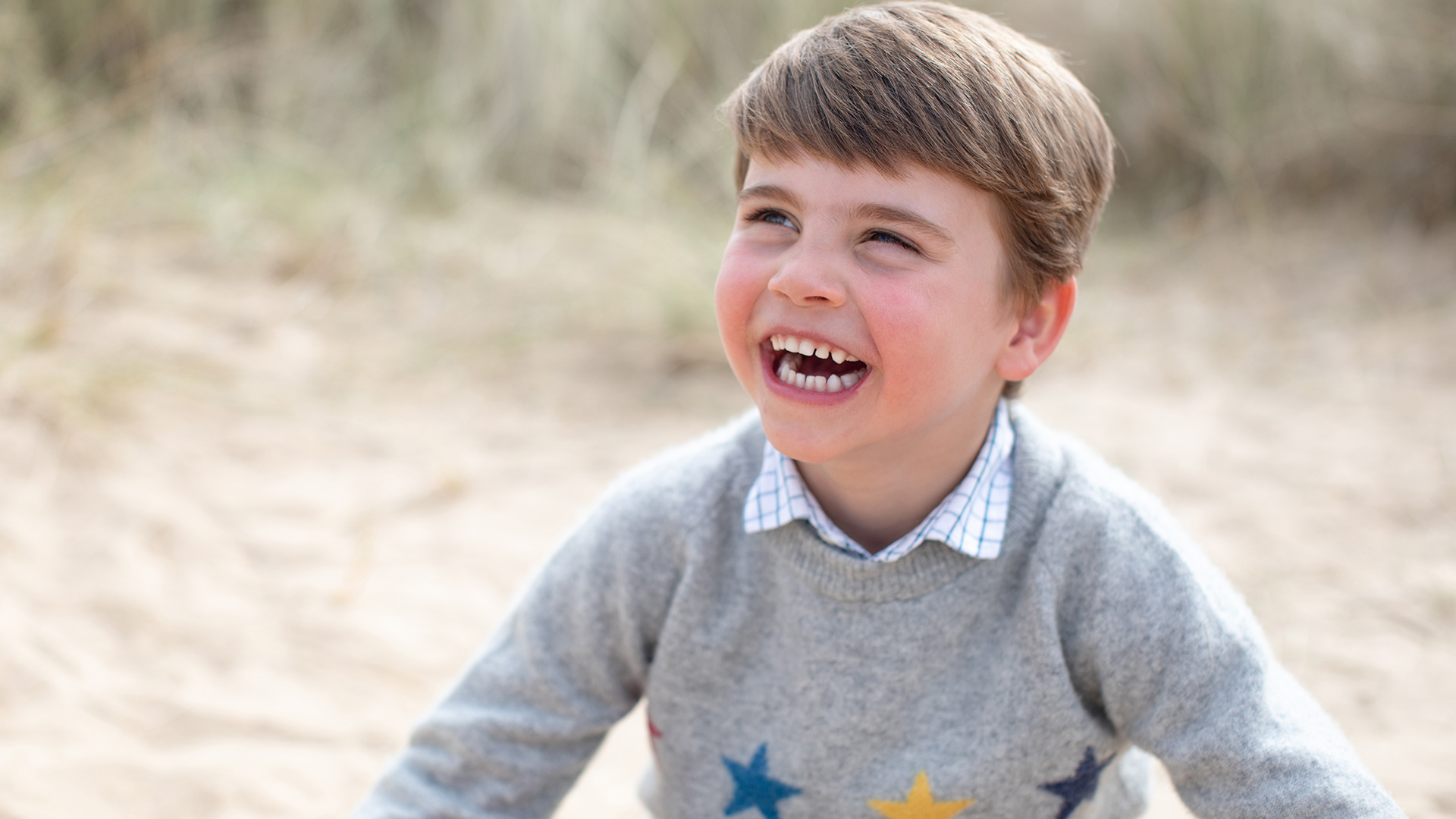 Prince Louis beams as he plays on the beach in cute photos for fourth birthday